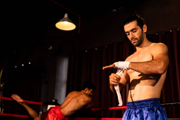 istock Caucasian boxer portrait wrapping his hand. Impetus 2085534751