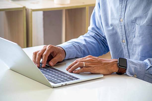 istock Businessman hand work on capable laptop computer at office table close up shot and selective focus at middle section of laptop computer keyboard while typing and working 2085536344