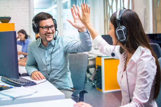 istock Customer support representative operators giving high five to each other celebrating successful task done at office. 2085610744