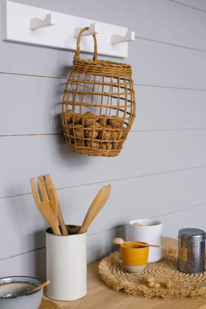 istock Modern kitchen interior with grey Scandinavian-style wood paneling on the wall, walnuts in the basket, crockery and kitchenware 2085613326