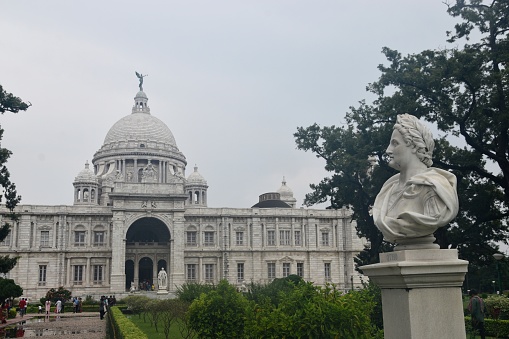 The Victoria Memorial is a large marble monument dedicated to Queen Victoria, the Empress of India facing the Queens Way on the Maidan in Central Kolkata. It was built between 1906 and 1921 by the British Raj. It is the largest monument to a monarch anywhere in the world.