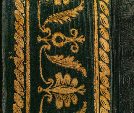 Turin, Piedmont, Italy - July 10, 2012: Old leather-bound book (detail of the gilded cover).