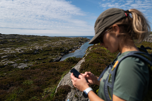 Woman hiking outdoors. Adventures in summer Norway, in the Bergen area.