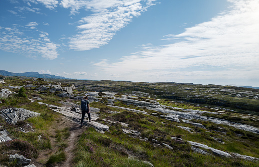 Young woman walking on a mountain road