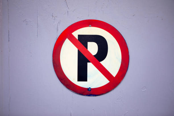 istock No parking sign on lilac coloured wall 2085658409