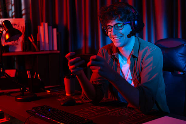 istock Smiling streamer team playing with Esport online on smartphone. Gusher. 2085659824