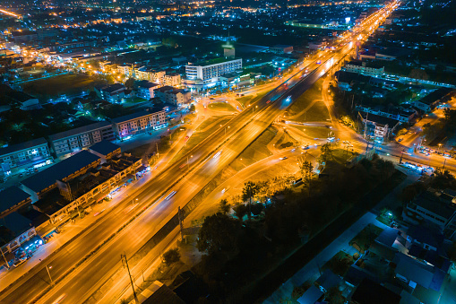 Traffic, drone view of city road crossing at night, drone point view of overpass and city traffic at dusk, traffic circle