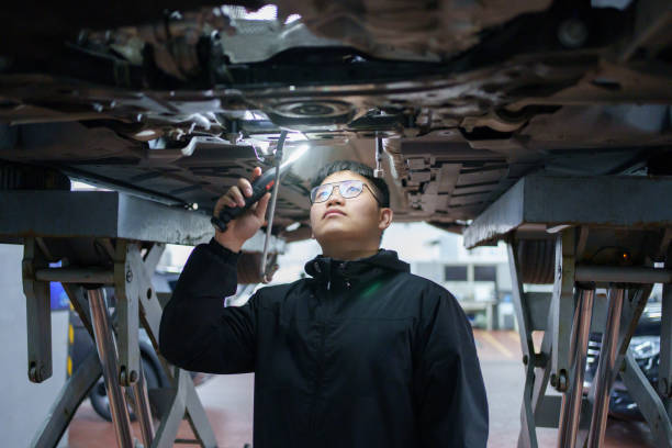 istock Worker is inspecting the car chassis 2085662975