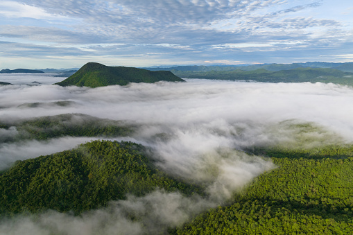 A stunning aerial view of the morning mist that covers the surrounding mountains. Nong Ya Plong District in Phetchaburi, Thailand.