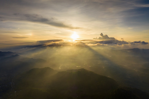 Aerial photography, The morning sun rises over a sea of mist, casting warm light.