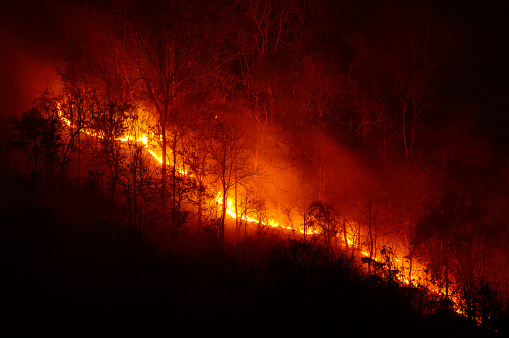 A forest fire is burning in the mountains in autumn. Mae Mo District, Lampang Province, Thailand, experiences dry air from mid-February to April of each year.