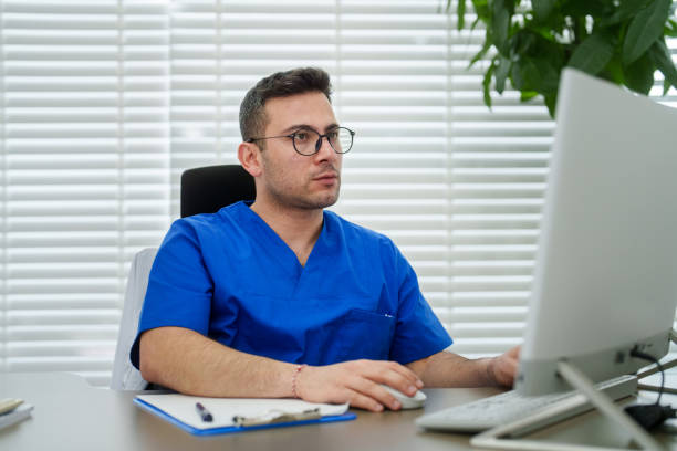 istock Healthcare worker using computer in the clinic office. 2085666410
