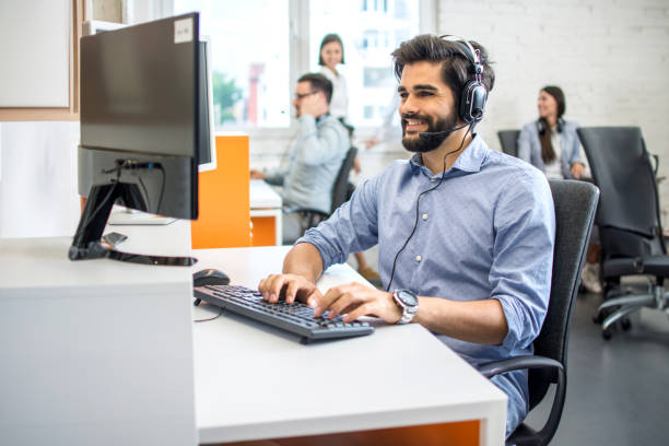 istock Handsome male customer support phone operator with headset working in call center. 2085678590