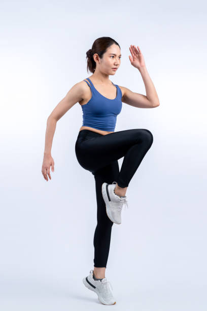 istock Side view young athletic asian woman on running posture. Vigorous 2085679165