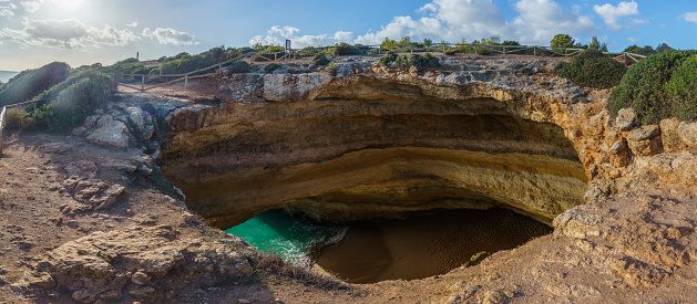Panorama of Benagil cave from above with view at the beach inside near Lagoa town, Algarve, Portugal.