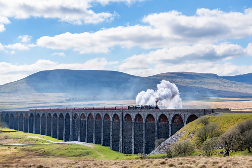 Locomotive steam trains crossing the Ribblehead Viaduct in the Yorkshire Dales, England, UK