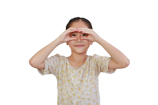 Asian little child girl looking through imaginary binocular isolated on white background with clipping path.