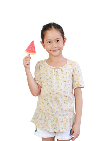 Asian little girl holding piece of sliced watermelon isolated on white background with clipping path