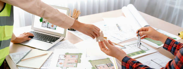 istock Profession engineer and architect collaborate on eco house project. Delineation. 2085703792