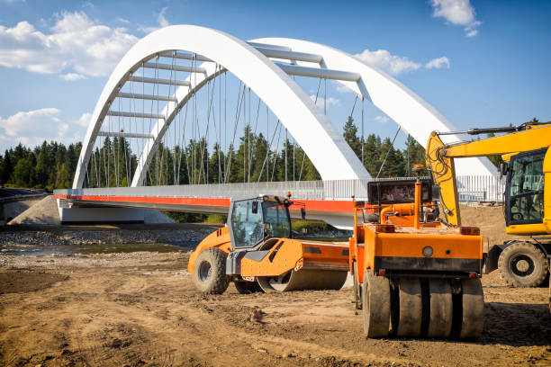 Road construction machines on the road and bridge construction site at Dunajec River in Malopolskie province, Poland