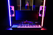 Modern equipment in the recording studio with neon lighting.