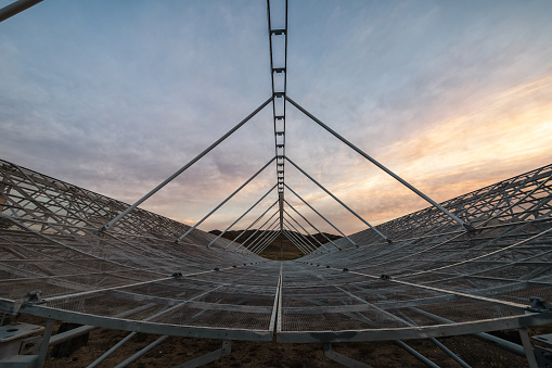 Radio antenna dishes of the Very Large Array radio telescope at  sunset