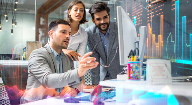 Business team working together on project on computer, checking the increase of profitability.
