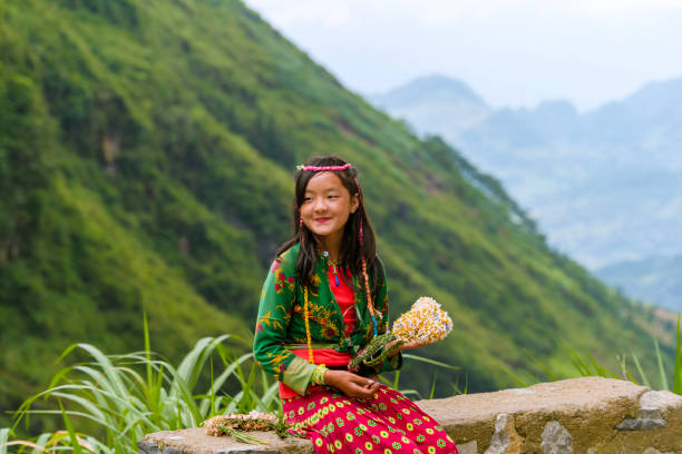 A cheerful Southeast Asian boy walking outdoors in a garden, wearing casual clothes. Perfect for family, childhood, outdoor activities, and healthy lifestyle concepts.