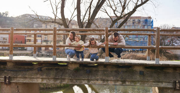 istock Happy young family in looking down in a bridge 2085808119