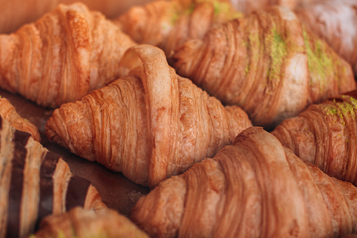 Freshly baked classic croissants. Assortment of baked goods on the counter