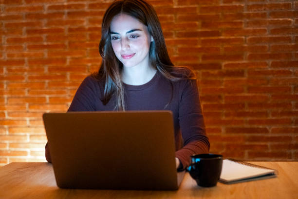 istock Portrait of young happy woman using laptop at night, using modern technology havinmg fun with glowing screen in dark office or at home, startup business meeting online with businesswoman 2085820583