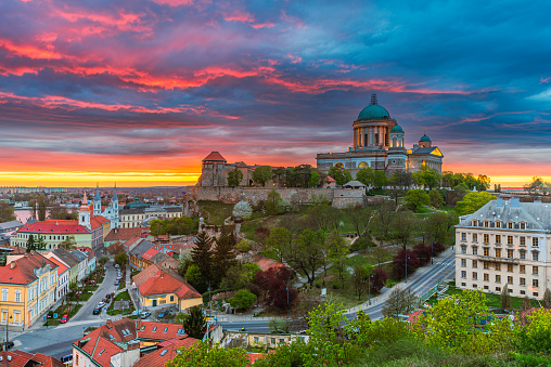 Colourful dusk with rainy clouds above behind the illuminated basilica of Esztergom in Hungary.