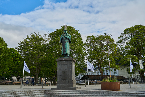 Stavanger, Norway - 05 29 2022: Bronze statue of Alexander Kjelland, at the market square in the port of Stavanger, sunny day, Norway.