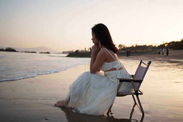 Beautiful woman sitting on the beach