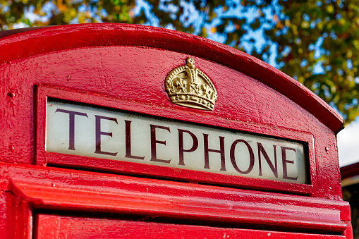 Close-Up view of Telephone sign on Red Telephone Box in London,UK