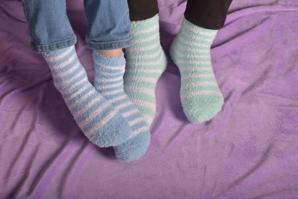 foot of two people with socks