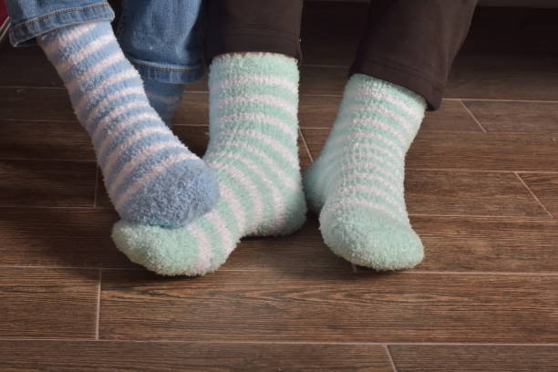 foot of two people with socks