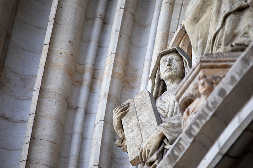 Statue of Virgin Mary in Roman Catholic Church on wall background.