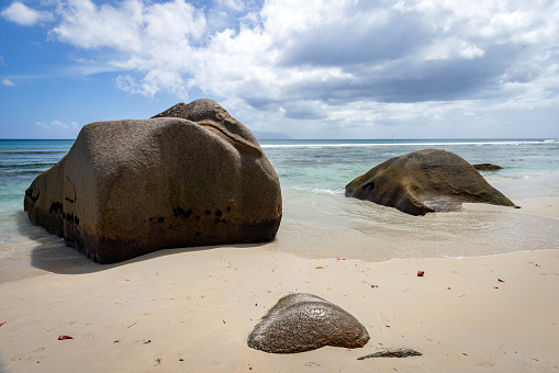 Coastal view with white sand and coastal stones. Landscape of Beau Vallon Beach, Seychelles