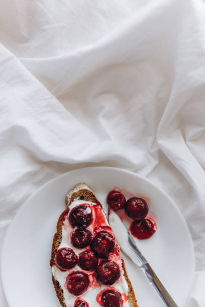 istock Aesthetic breakfast, bread with white cheese and cherries 2085932640
