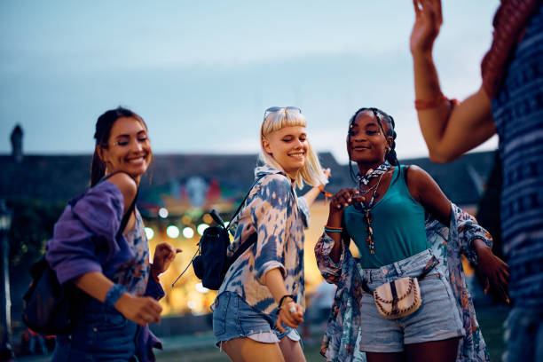 istock Happy people dancing while attending open air music concert in summer. 2085946649