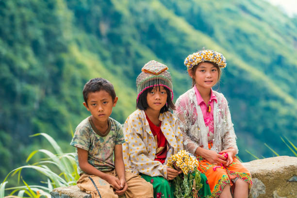HA GIANG, VIETNAM - CIRCA AUG 2019: H'mong children hanging out by the road.