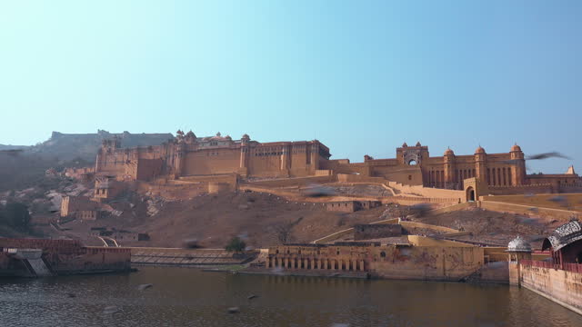 Facade view of the Amber fort in front of the lake