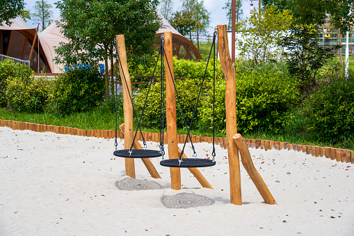 Swings in outdoor play sand pool