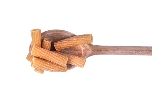 a small pile of wholemeal pasta on a wooden ladle