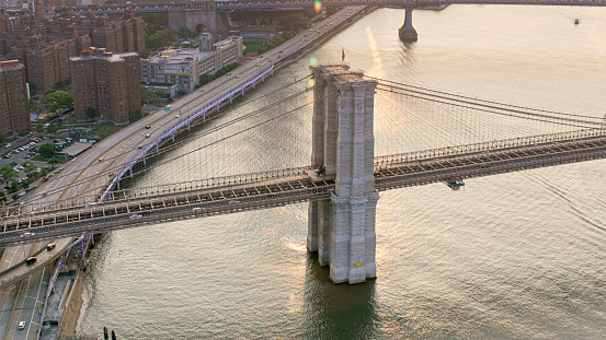 Aerial view suspension tower of Brooklyn Bridge over East River in New York City, New York State, USA.