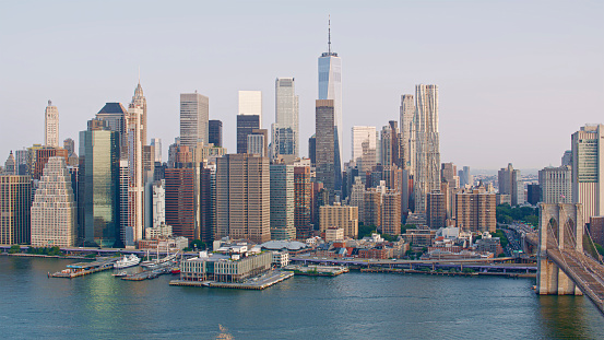 Aerial view of One World Trade Centre surrounding with downtown Manhattan Skyscrapers and Brooklyn Bridge over East River, New York City, New York State, USA.