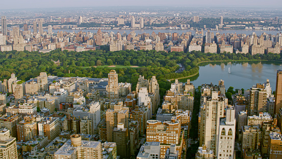 Aerial view of Central Park with Central Park Reservoir surrounded by modern skyscraper in New York City, New York State, USA.