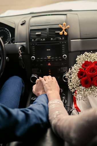a woman with a bouquet of roses in a car with a man