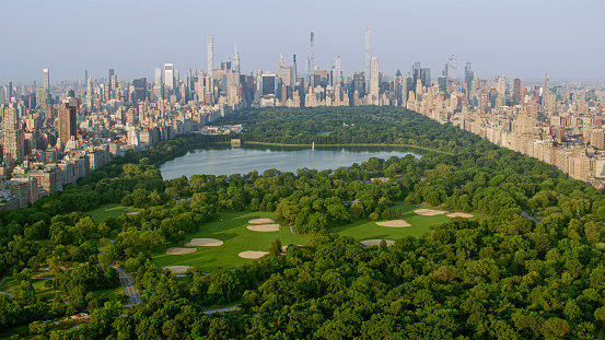 Aerial view of Central Park with Central Park Reservoir surrounded by modern skyscraper in New York City, New York State, USA.